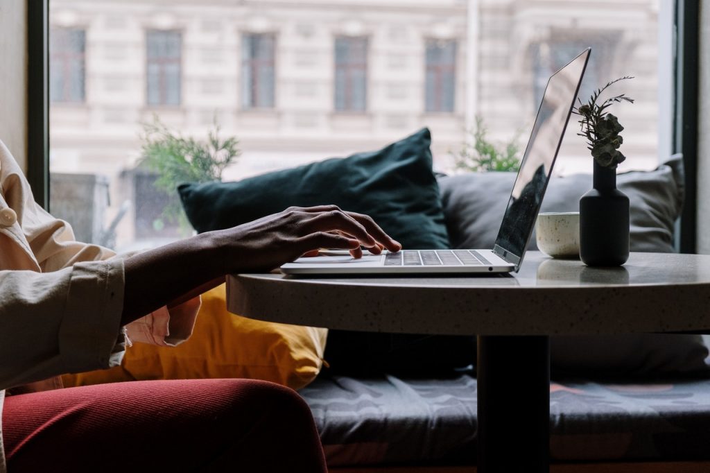 A person types on a laptop computer.