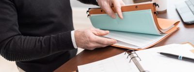 Businessman looking for document in folder