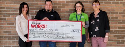 Michigan Works! presents Aspirus with a big check.
