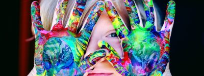 A picture of a child with paint on its hands to promote the Childcare Virtual Job Fair.