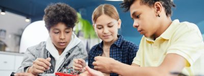 Kids are pictured working on a project together.